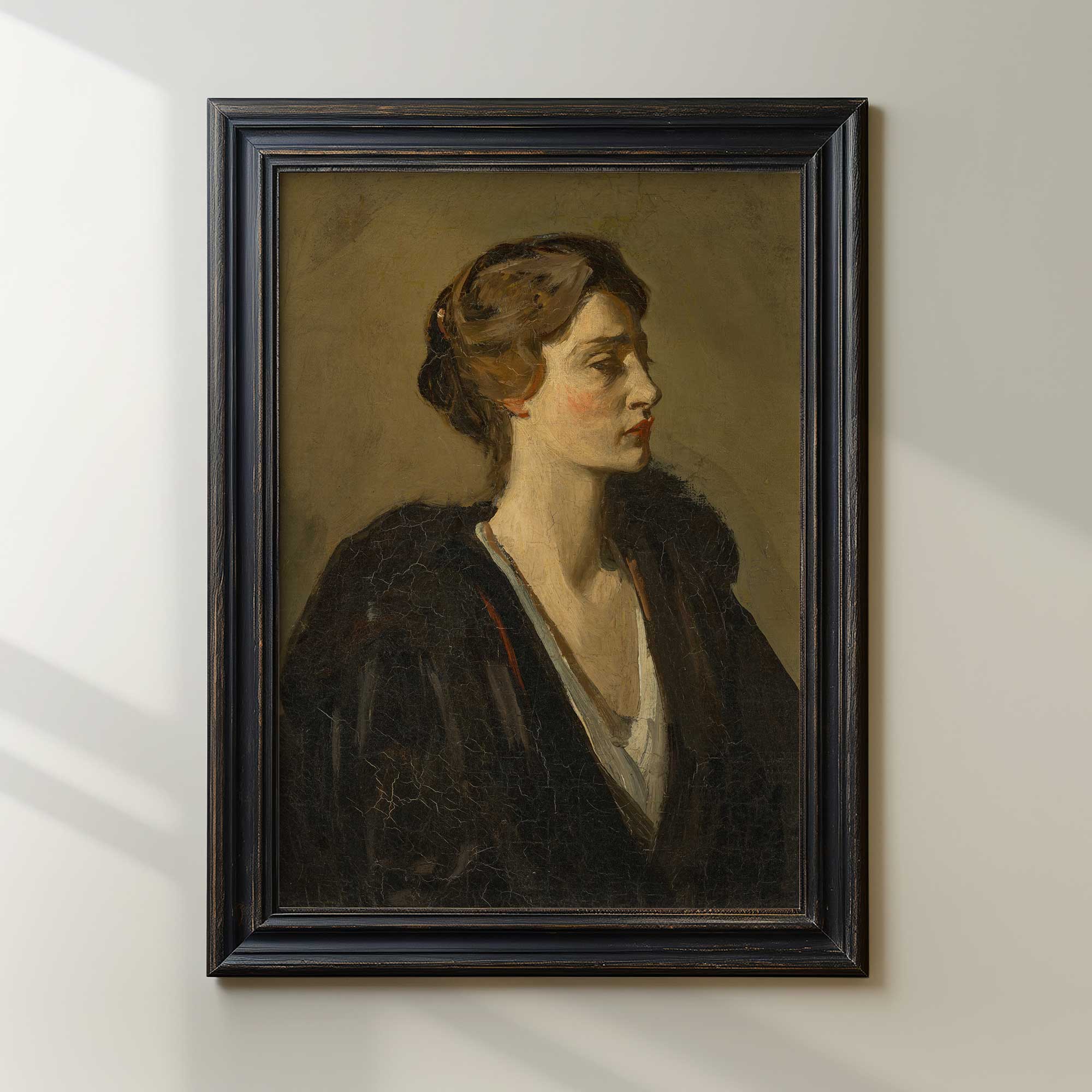 Framed portrait painting of a woman on a white wall