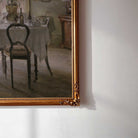 Close-up detail of vintage dining room print featuring a farmhouse table and woman by the window