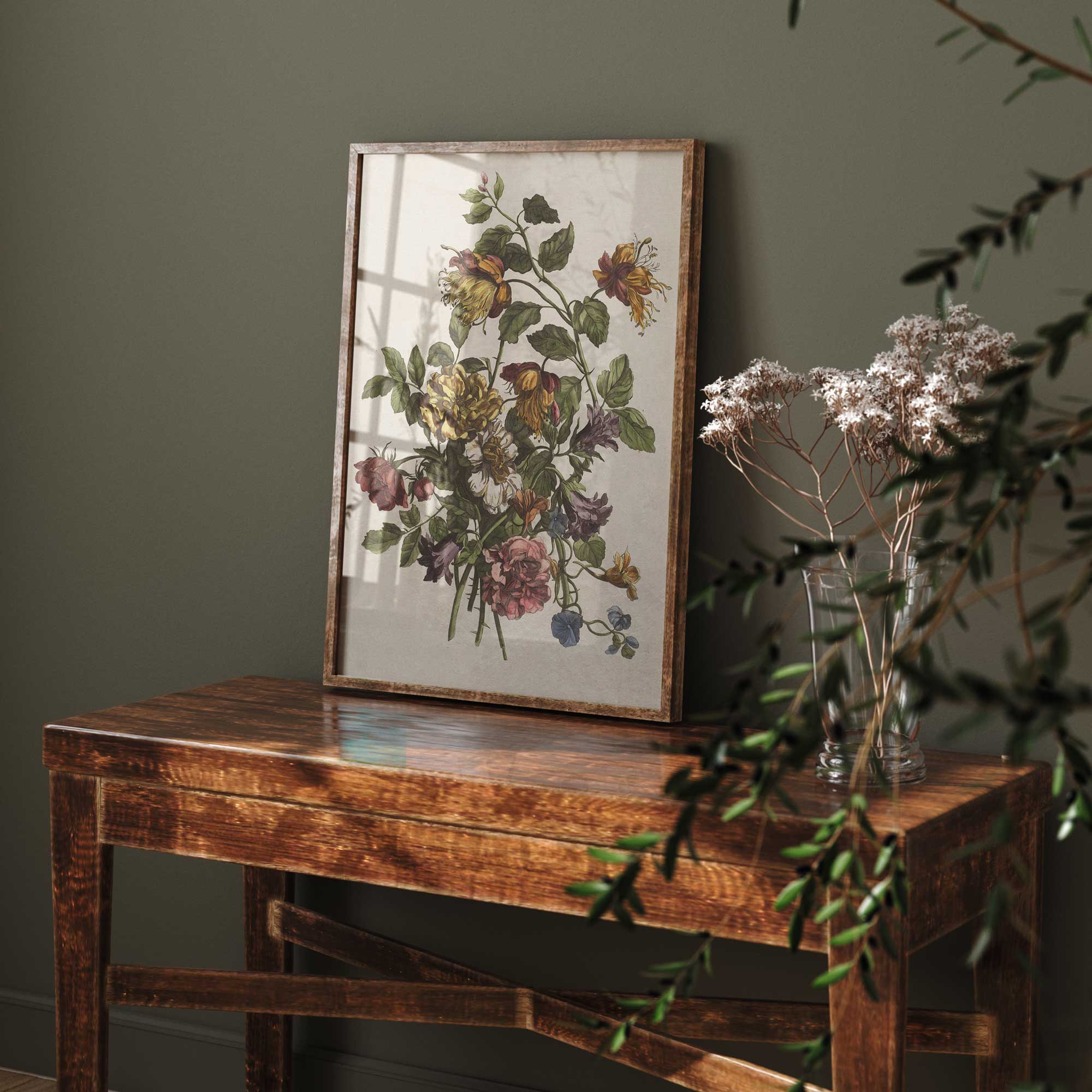 Framed botanical print on a wooden table with a dark green wall background