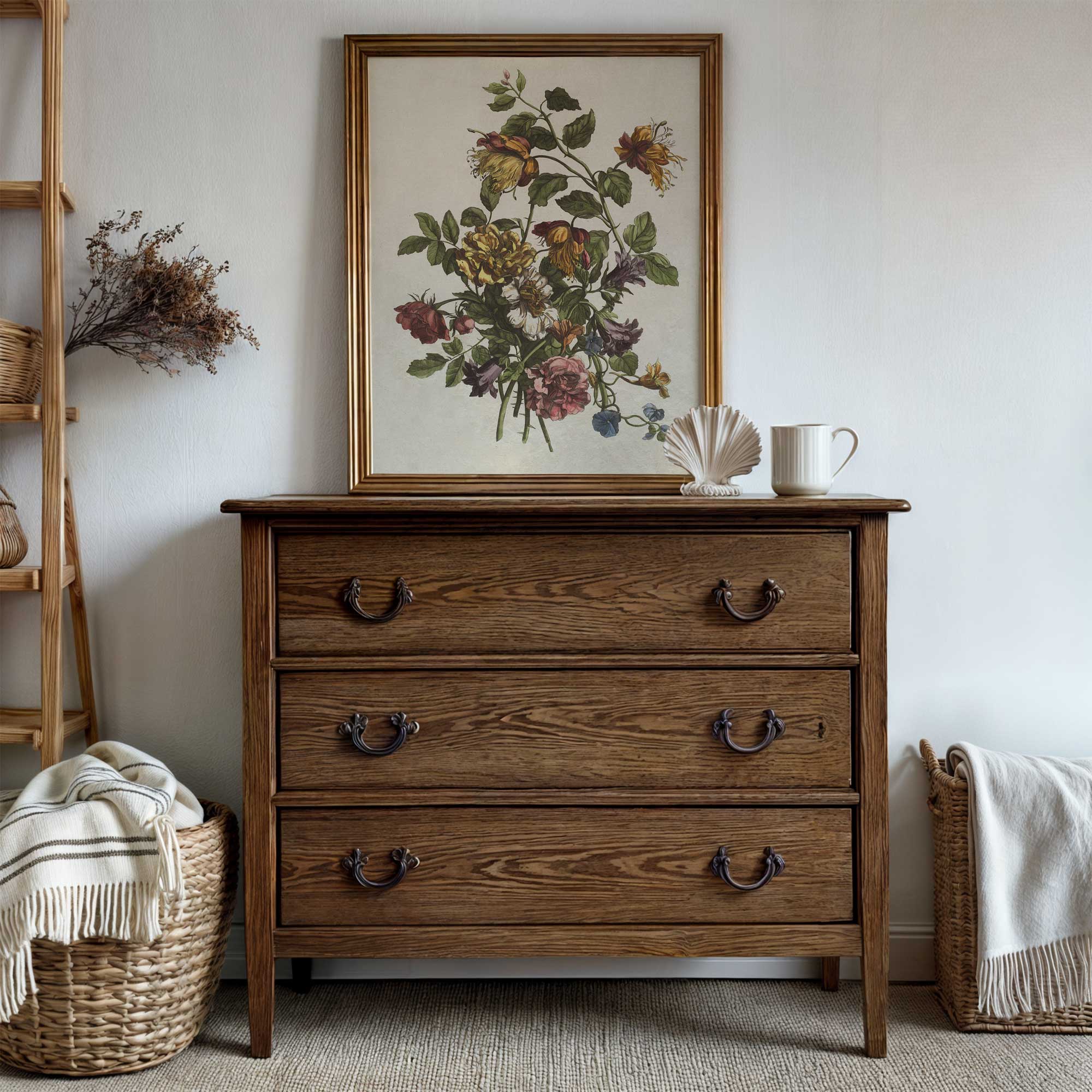Wooden dresser with floral painting above, wicker baskets on either side, and a neutral color scheme.
