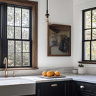 Vintage kitchen scene wall art displayed in a modern farmhouse kitchen with wooden frame