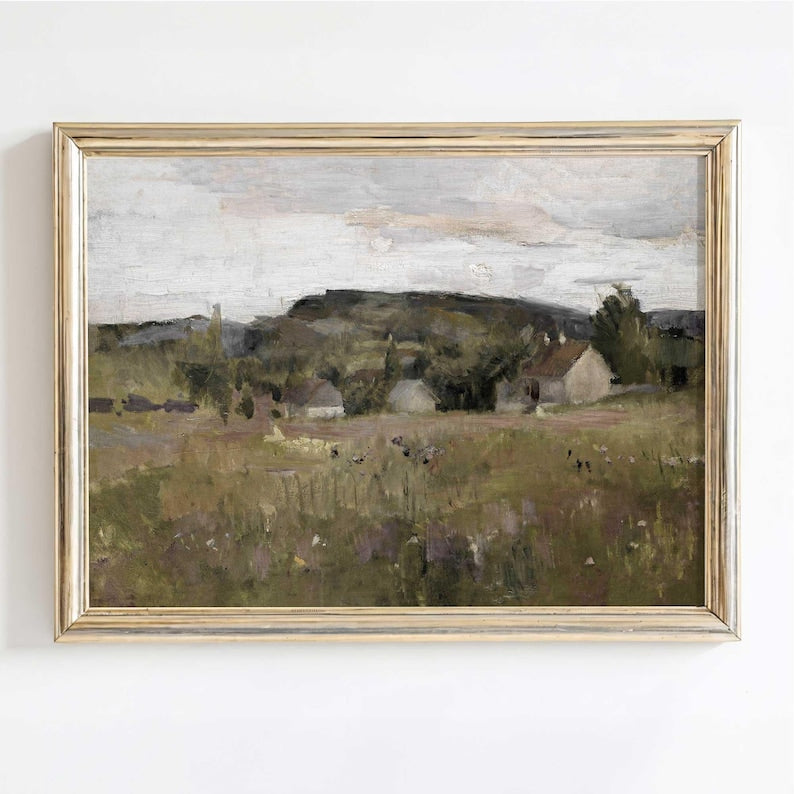 Nordic meadow and cottage landscape print in rustic wood frame on white wall.