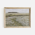 Framed artwork of Blooming Floral Meadow landscape on a white wall
