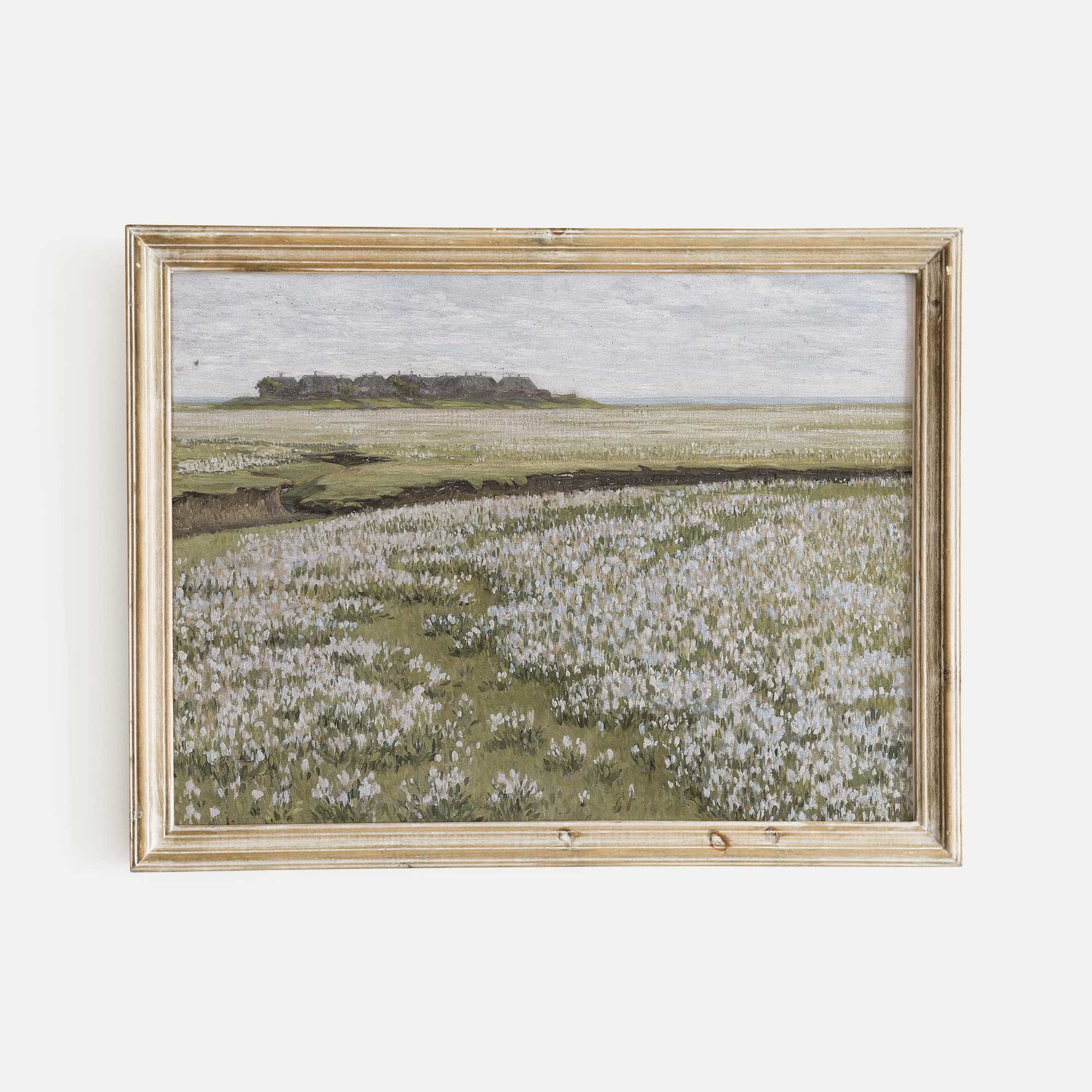 Framed artwork of Blooming Floral Meadow landscape on a white wall