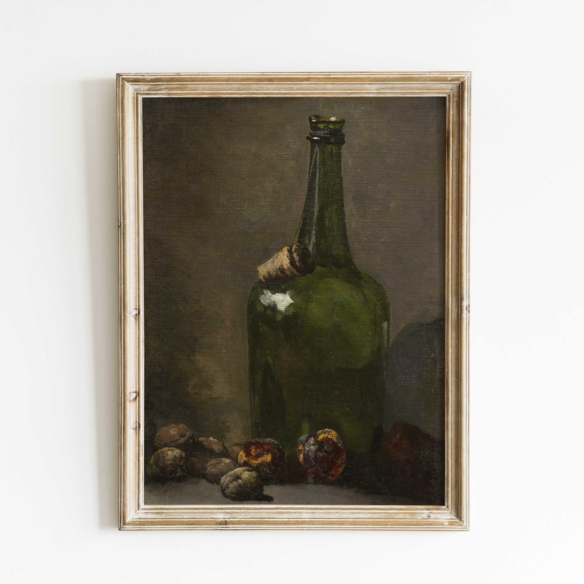 Framed painting of a still life with a green bottle and fruits on a white wall.