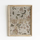 Decorative floral patterned fabric in a gold frame on a white background