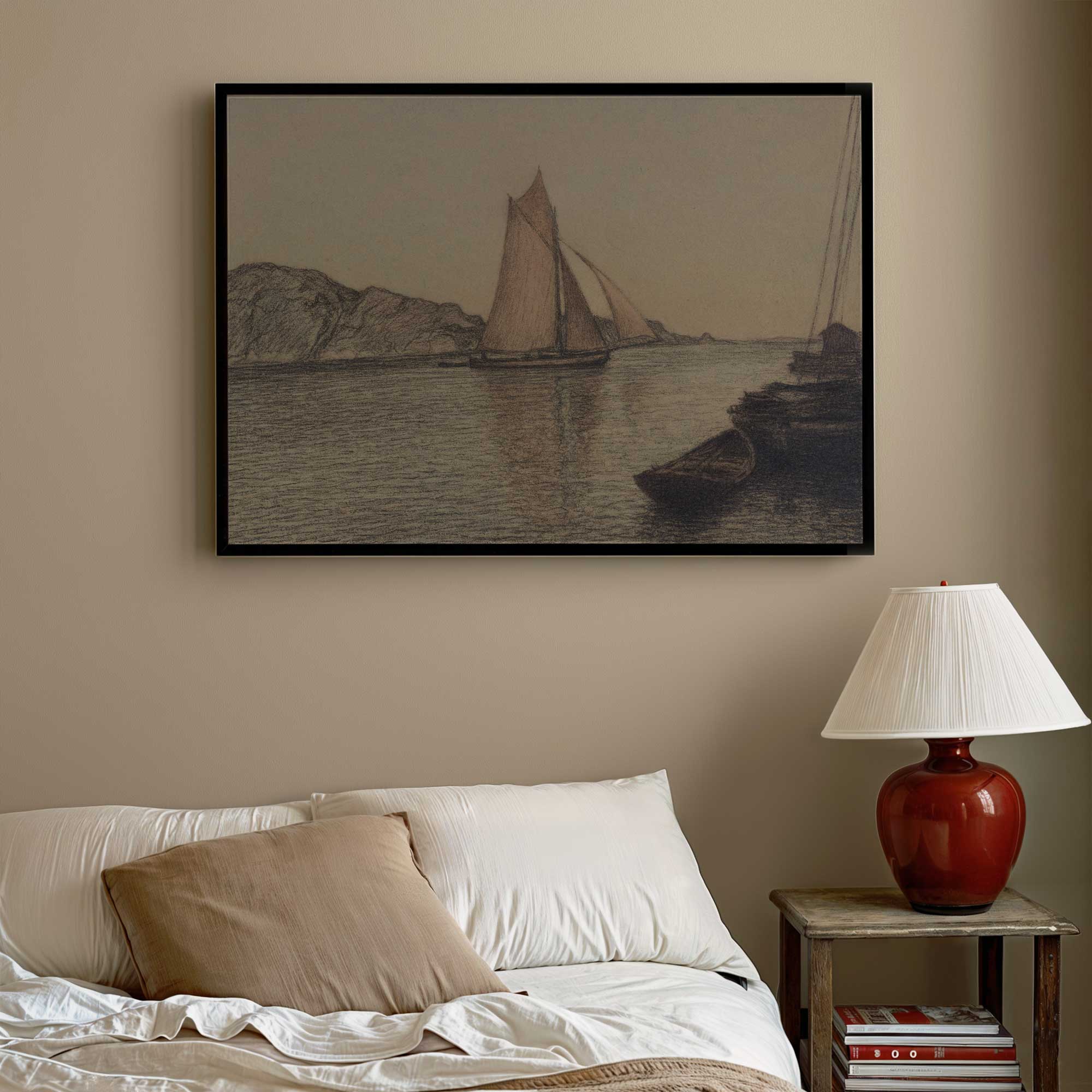 Framed artwork of sailboats on a wall above a bed with a lamp on a nightstand.