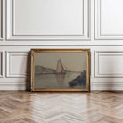 Framed painting of a sailboat on a wall with wooden floor