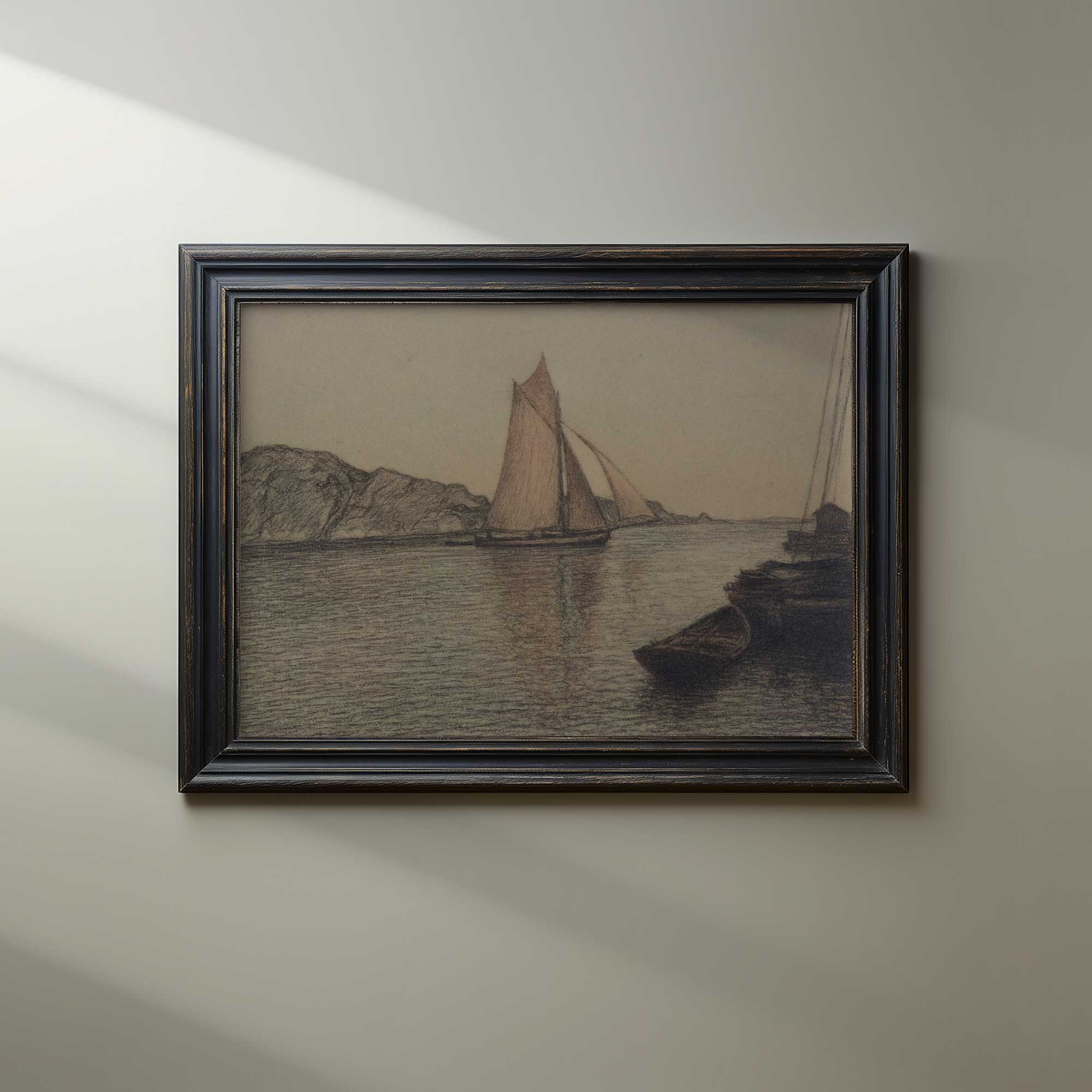 Framed artwork of sailboats on a body of water with mountains in the background, hanging on a beige wall.