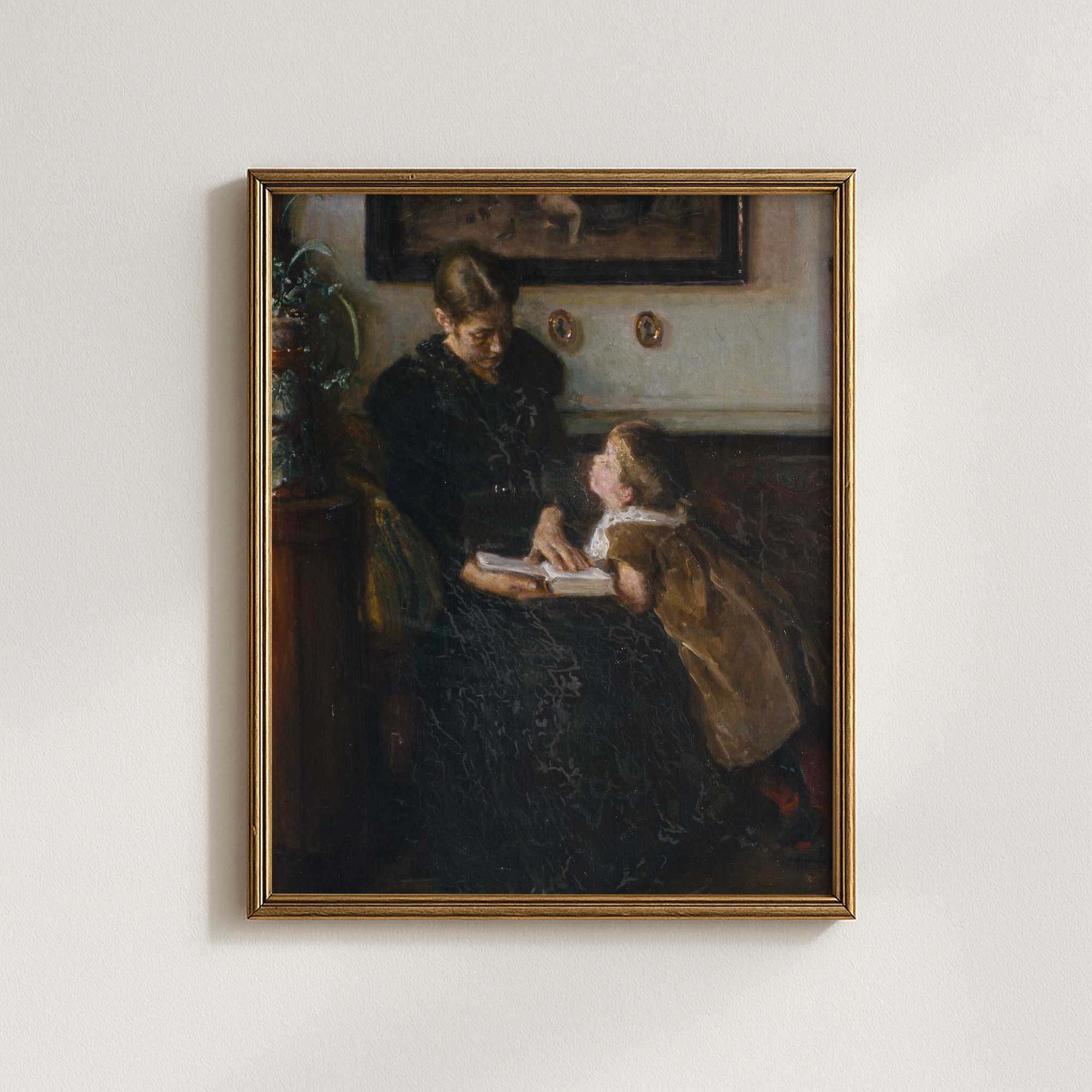 Vintage mother and child reading wall art displayed in modern gold frame
