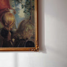 Close-up detail of vintage wall art depicting two young girls receiving a sewing lesson in a farmhouse home