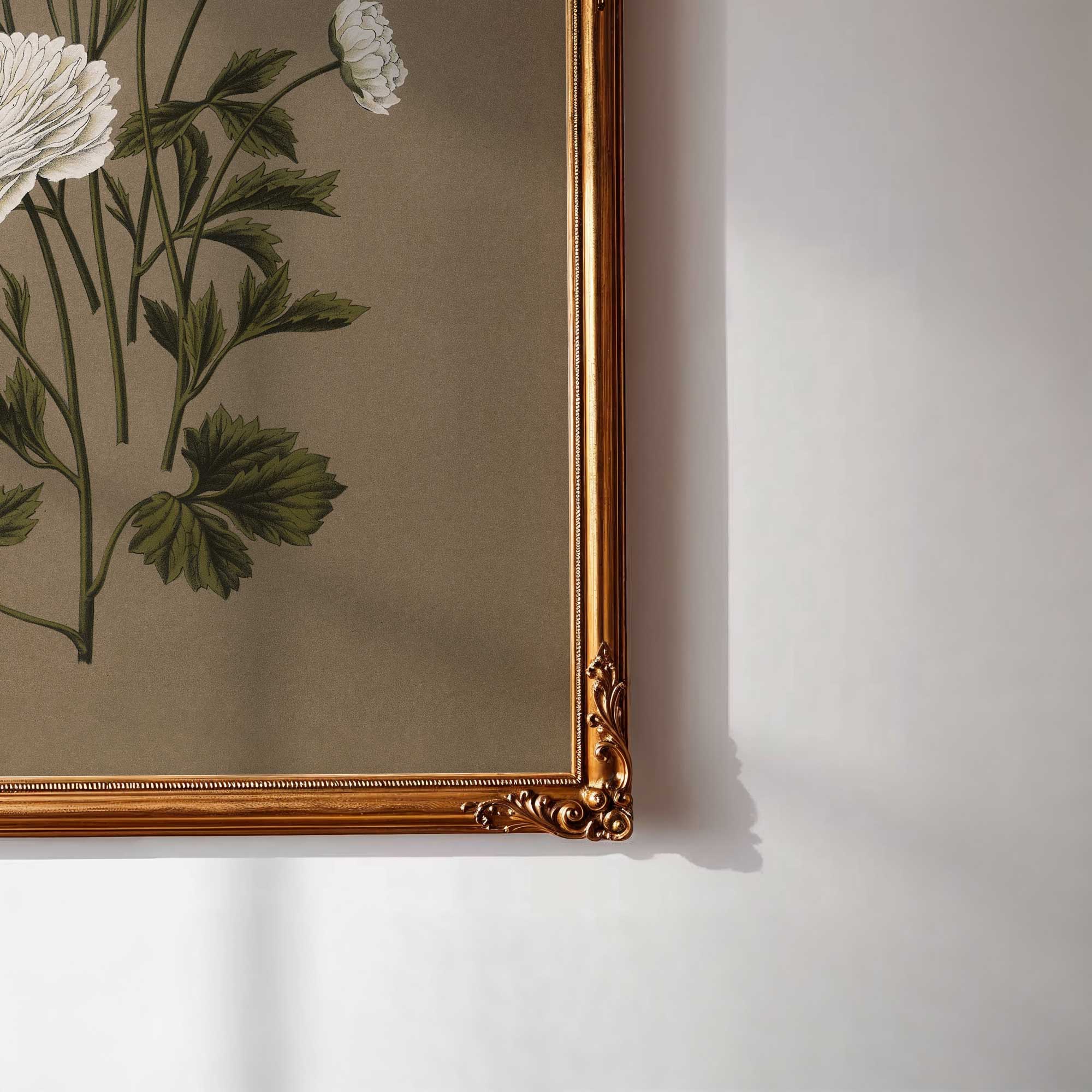 Framed botanical artwork with flowers and leaves on a plain wall.