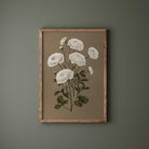 Framed floral artwork on a green wall