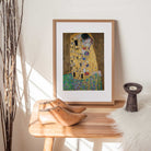 Gustav Klimt – The Kiss, vintage golden fine art print in wooden frame on a console table 